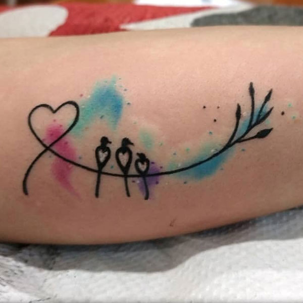 An amazing tattoo with birds, hearts, and color