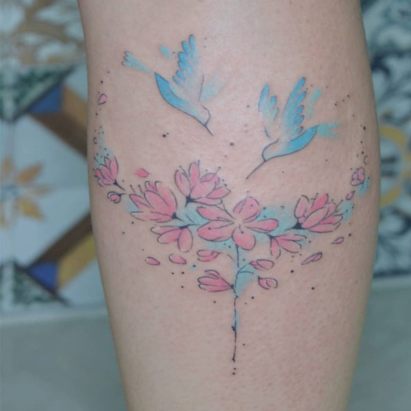  Small Colorful hummingbird with flowers tattoo