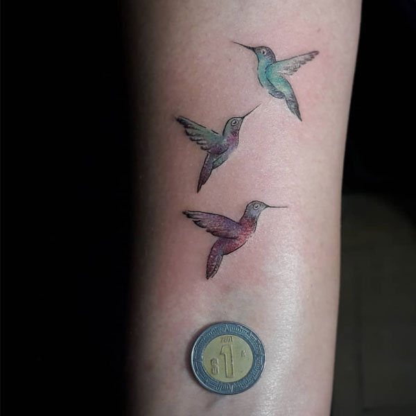 Beautiful colorful small hummingbirds tattoo.