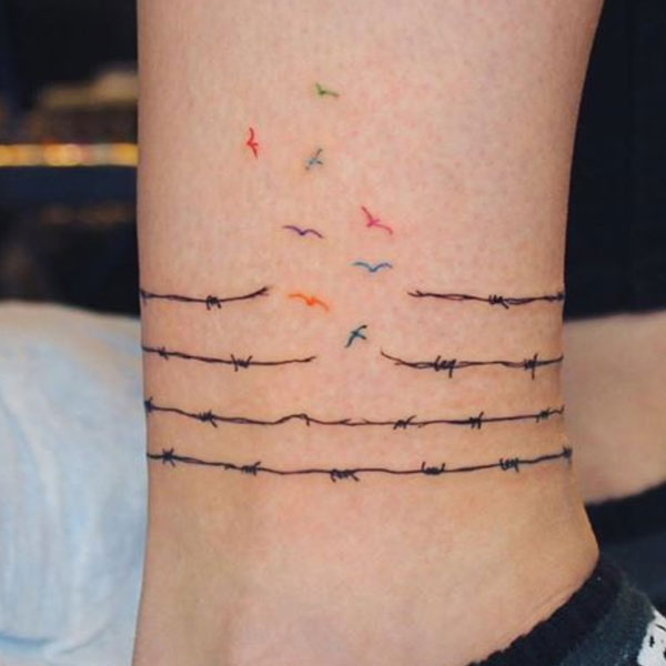 Small birds escaping barb wire tattoo