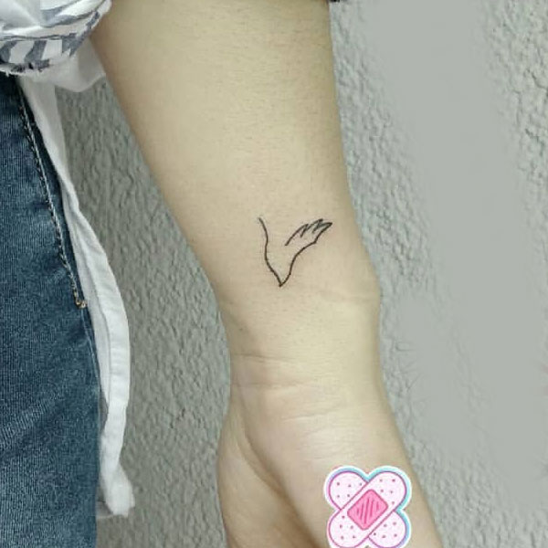 Bird minimal line tattoo on wrist