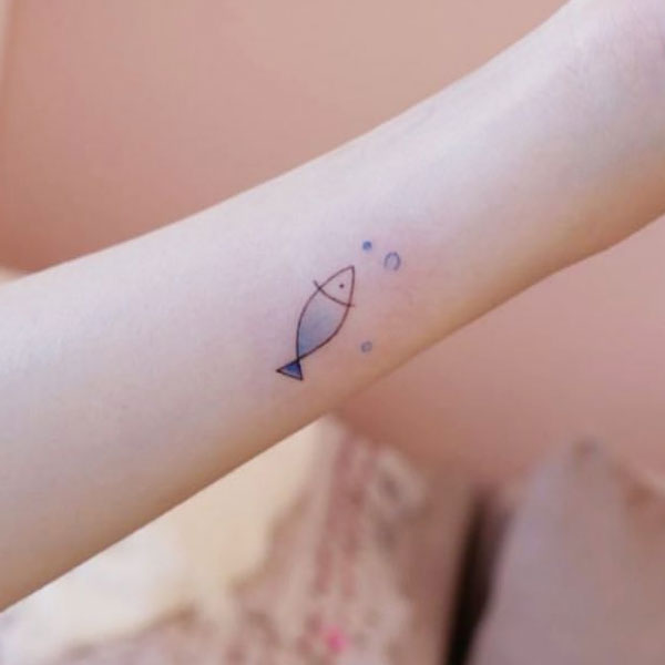 Tiny charming mini fish tattoo