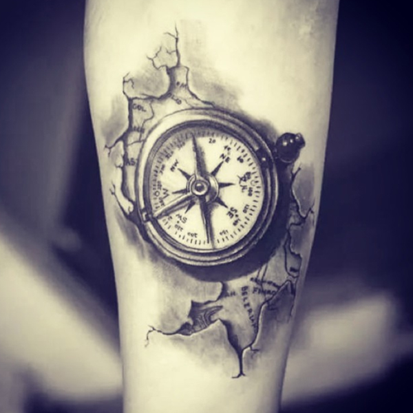 Awesome ripped skin compass design tattoo