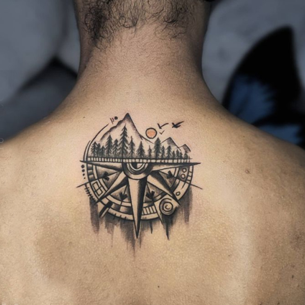 Stunning half compass and mountain tattoo for travelers