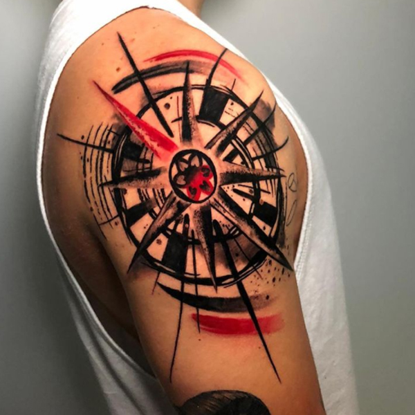 Dazzling brush stroke compass on the bicep