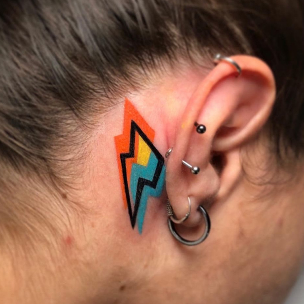  A bold colorful tattoo behind the ear