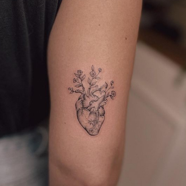 Amazing botanical heart tattoo on the back arm