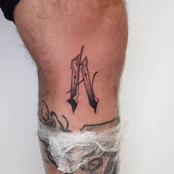 Amazing A-letter tattoo design on the leg