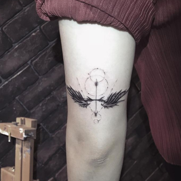 Attractive arrow abstract style and wings tattoo design