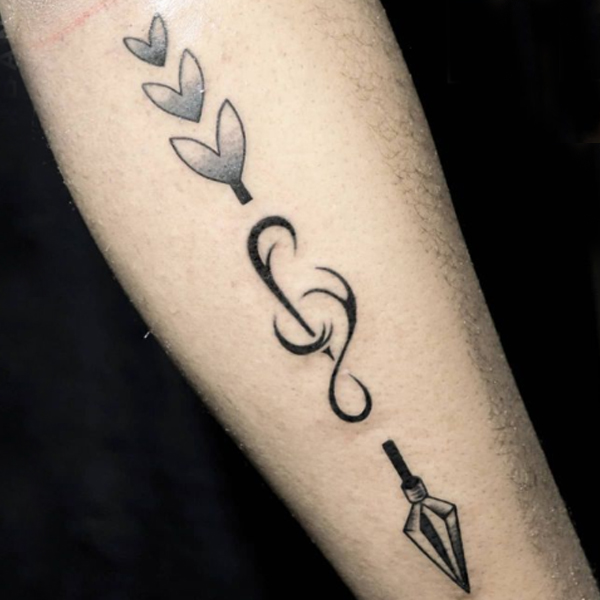 Stunning black arrow and custom musical tattoo design