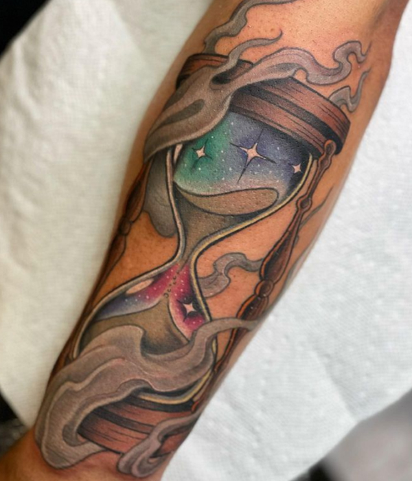 Attractive hourglass watercolor tattoo on the hand