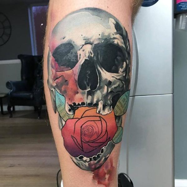 Stunning Skull grip a rose flower colorful tattoo