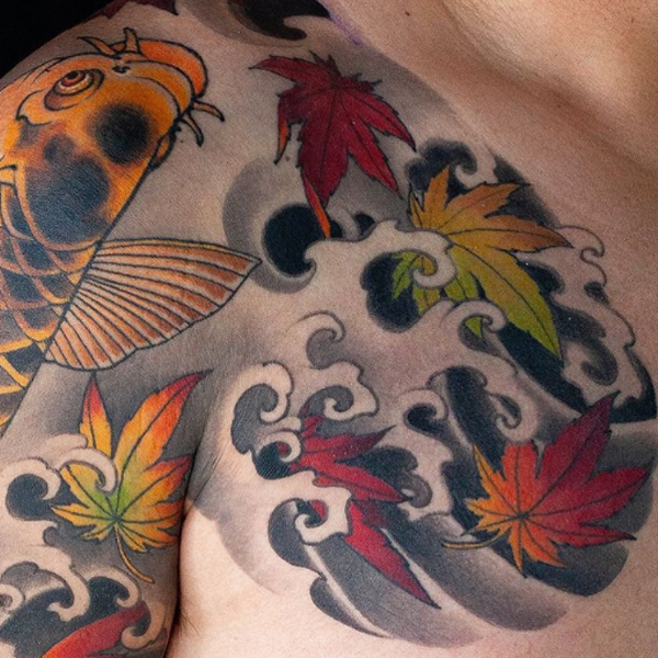 Stunning Koi fish, maple leaf and finger wave tattoo